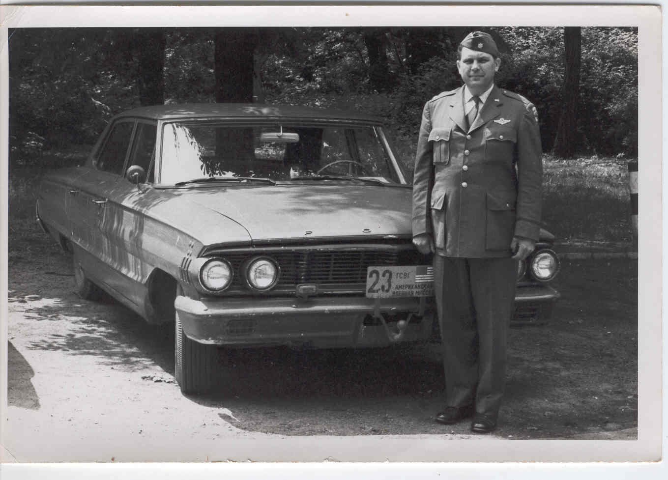 <span style="font-size:18px; ">&nbsp;1962-63 &nbsp;Somewhere in the Zone, my father with &ldquo;his&rdquo; car. &nbsp;My father was very proud of this car. &nbsp;He helped design it with the manufacture and had it air shipped via C47, I believe, to Germany - for&nbsp;what would have been in their day a new &nbsp; hot rod to take the road at high speeds at night. &nbsp;His driver was Mel Ratz.<br />Photo provided by Anne-Marie Fitzurka Cooper</span>